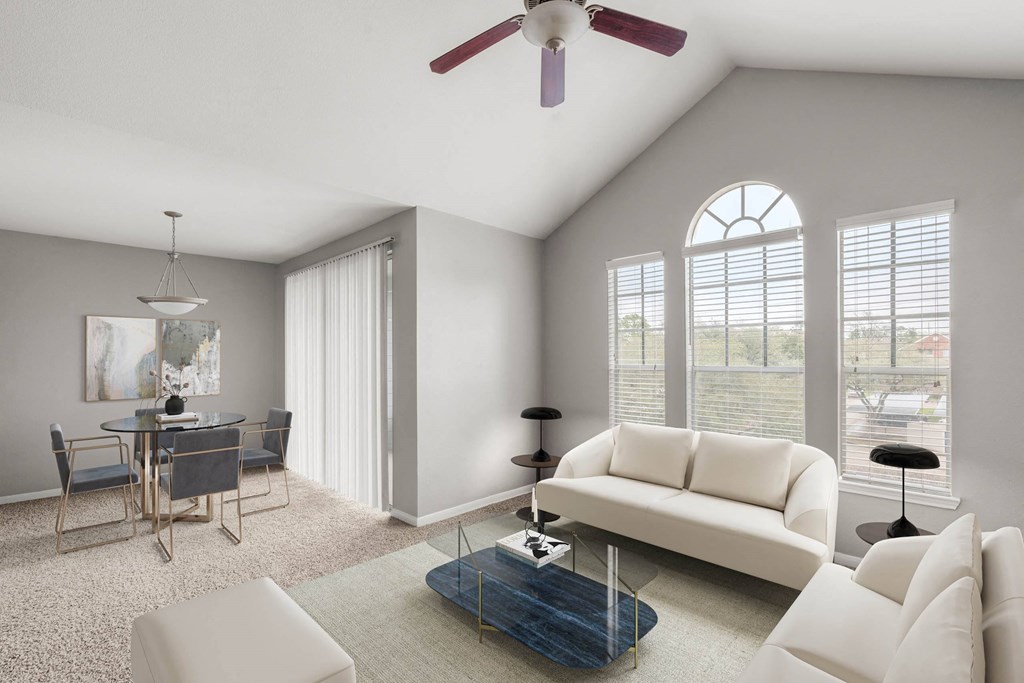 a living room with white furniture and a table with chairs at Veranda at Centerfield, Houston, Texas