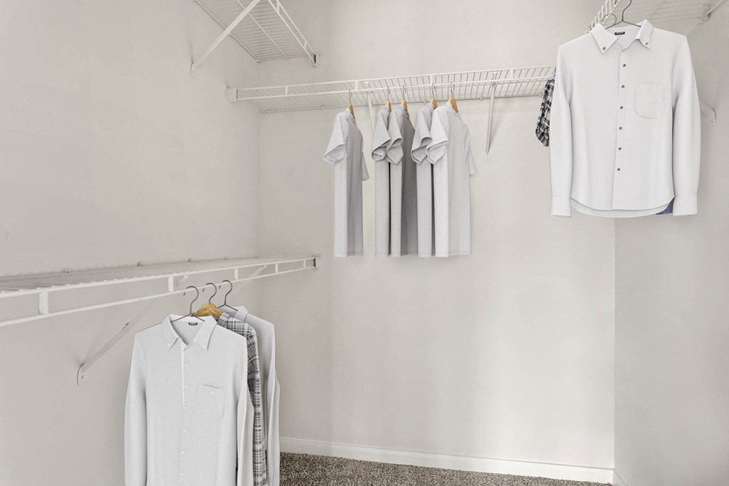 a white closet with white shirts hanging on a rack at Villages of Cypress Creek, Texas, 77070