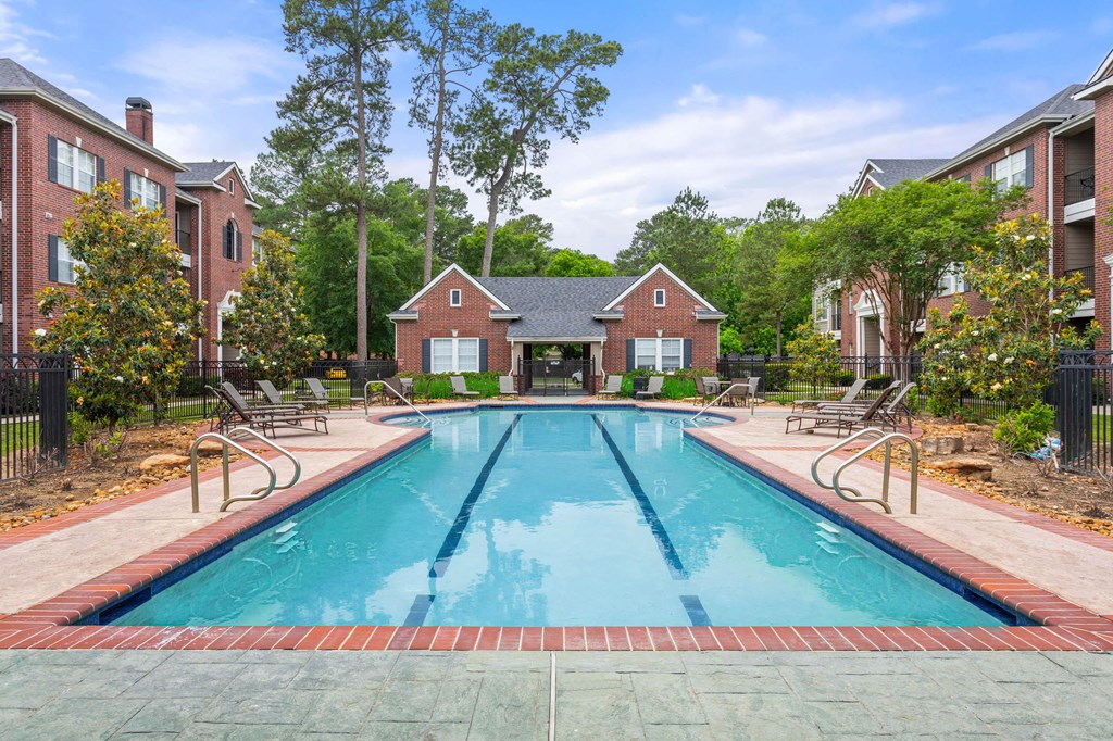 a swimming pool with a house in the background at Villages of Cypress Creek, Houston, Texas