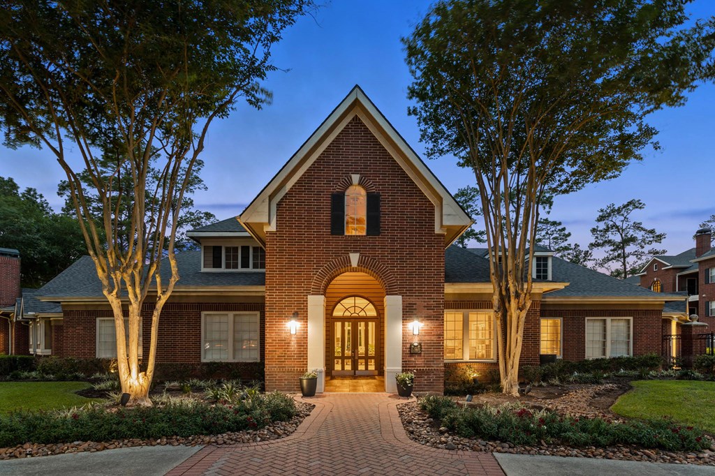 the front of a brick house with a walkway and trees at Villages of Cypress Creek, Texas, 77070