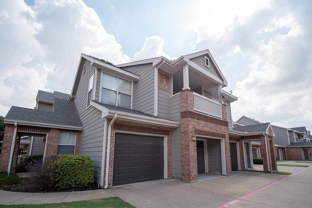 a house with a garage door in front of itat Creekside at Legacy, Plano, 75024