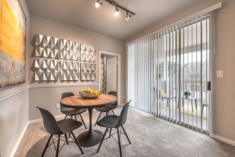 a dining room with a table and chairs and a large windowat Creekside at Legacy, TX 75024