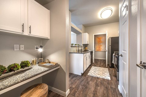 a renovated kitchen with white cabinets and stainless steel appliancesat Creekside at Legacy, Plano, TX