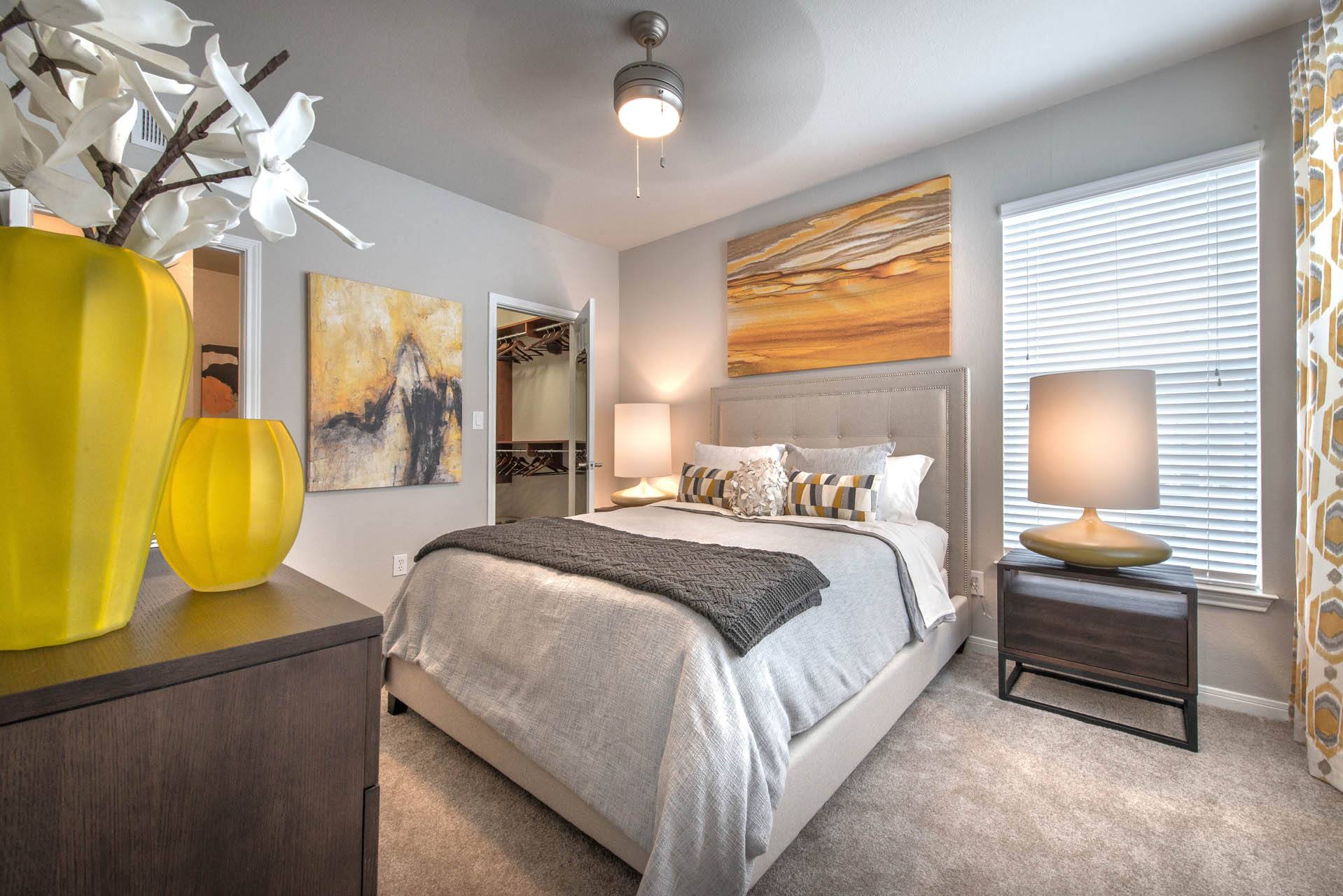 a bedroom with a large bed and a yellow vase at Creekside at Legacy, Plano
