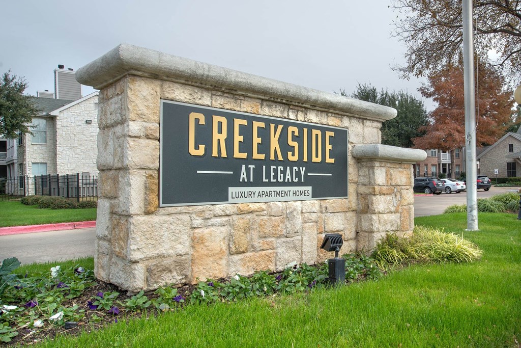 a sign at lead in front of a buildingat Creekside at Legacy, Plano