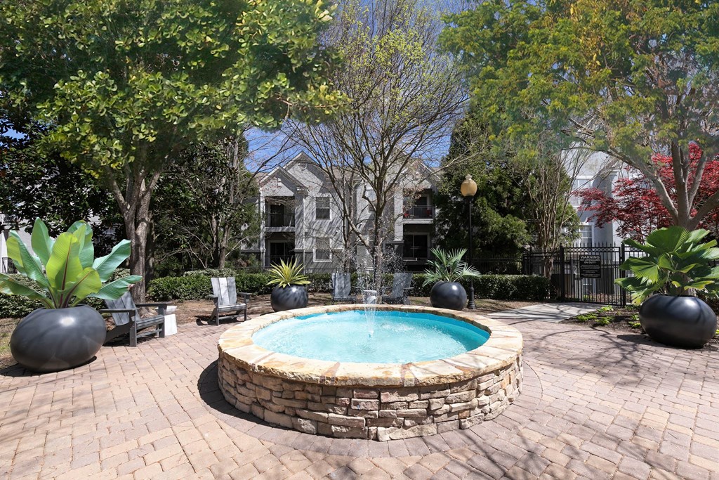 a round swimming pool in a backyard with trees and a house at Deerfield Village, Alpharetta, Georgia