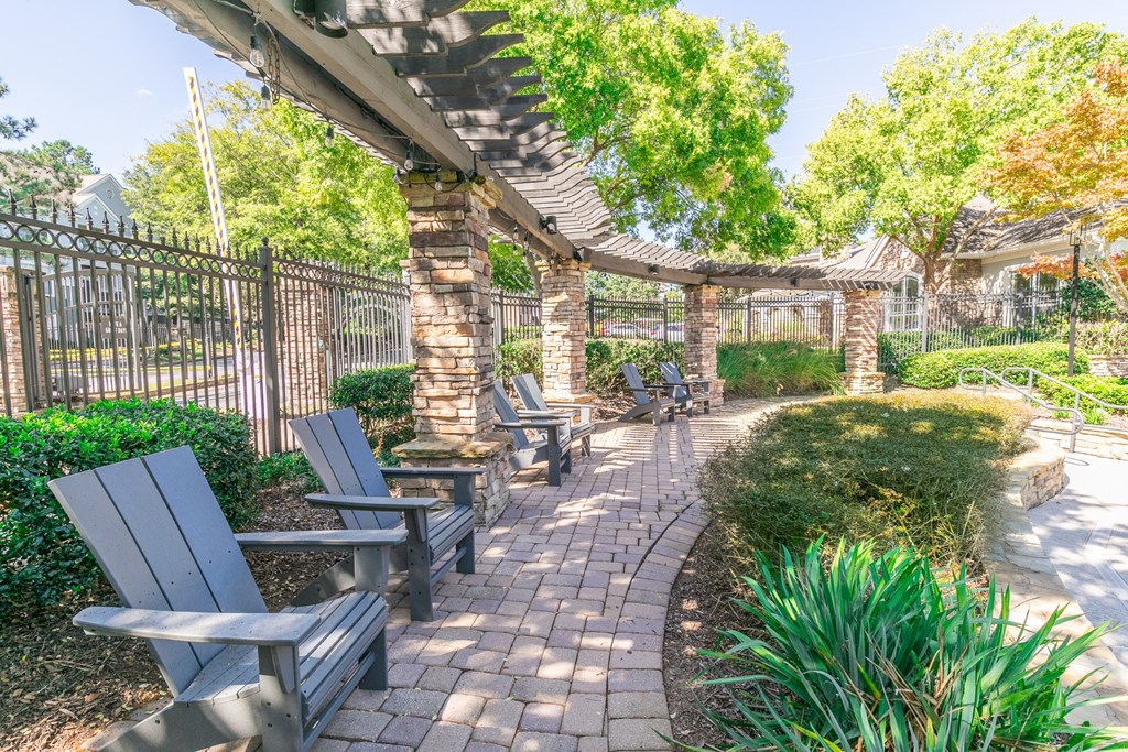 a patio with benches and a fence and trees at Deerfield Village, Alpharetta, GA, 30004
