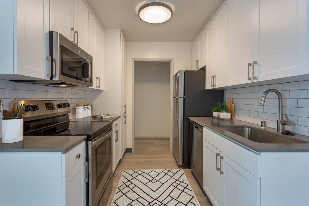 a kitchen with a sink and a refrigerator at Delphine on Diamond, San Francisco, CA