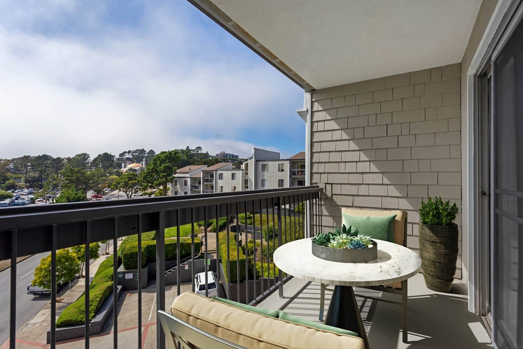 a balcony with a table and chairs and a city view at Delphine on Diamond, San Francisco, California