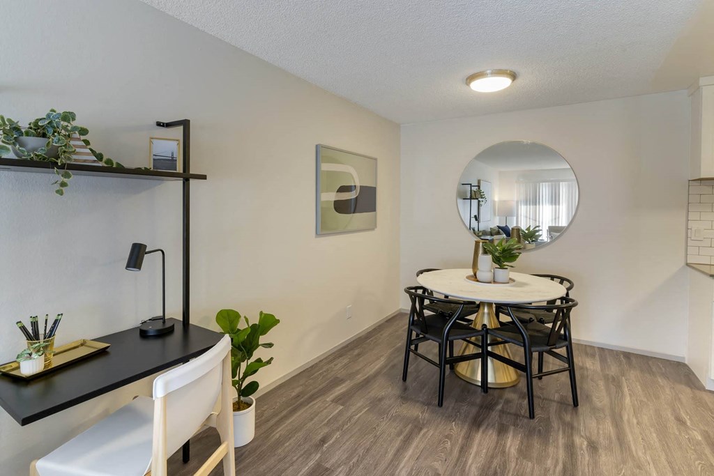 a dining room with a table and chairs and a mirror at Delphine on Diamond, San Francisco, CA