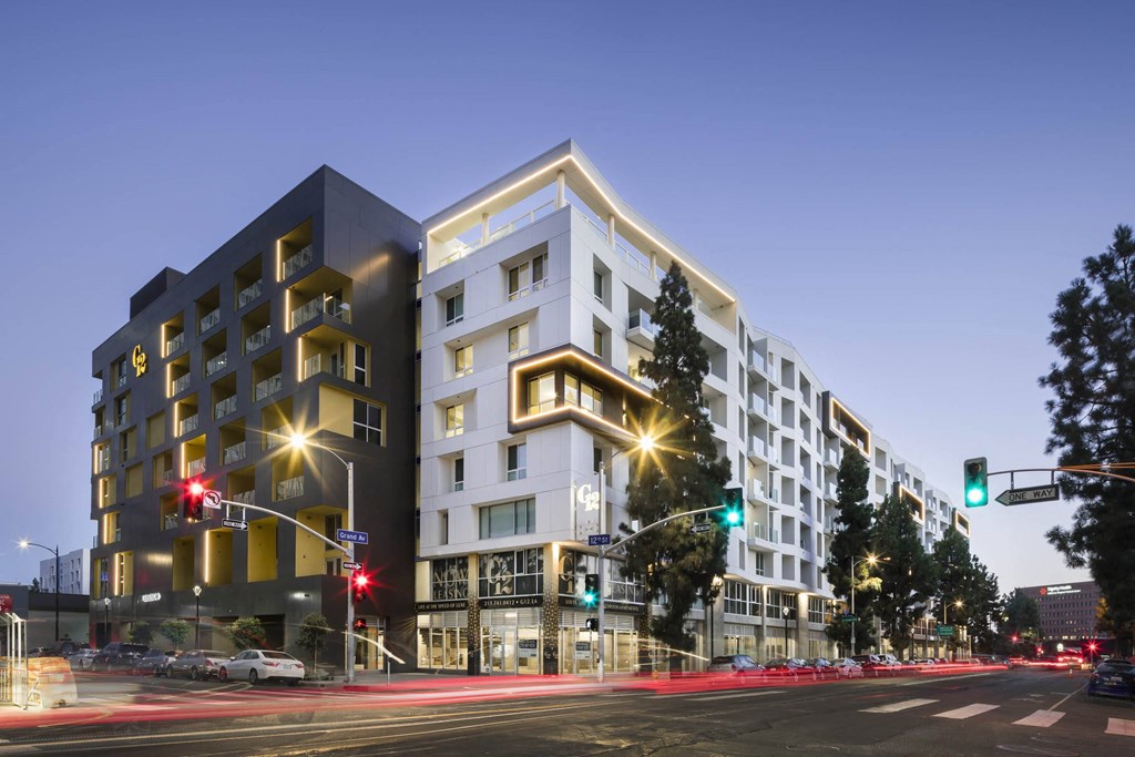 A modern building with a black and white facade stands on a street corner at G12 Apartments, Los Angeles, California