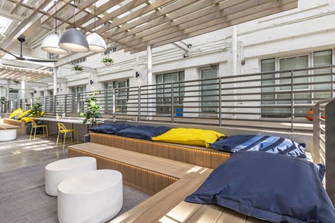 a common room with beds and a table and chairs at Highland Mill Lofts, Charlotte, 28205