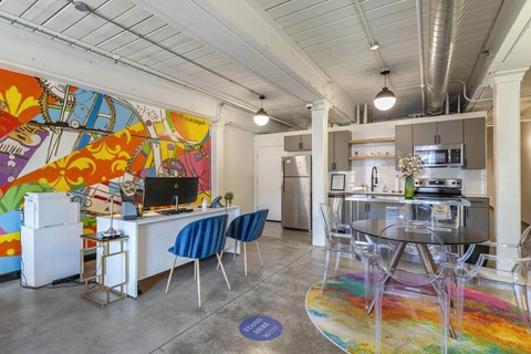 a living room with a kitchen and a table and chairs at Highland Mill Lofts, Charlotte, 28205