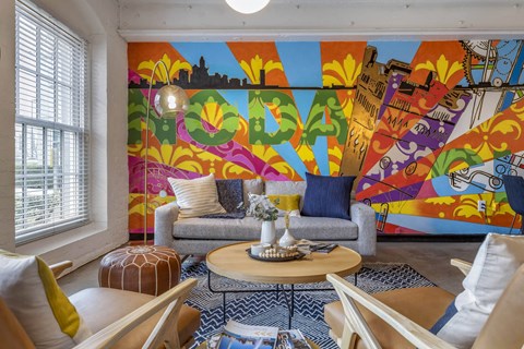 a living room with a colorful mural on the wall at Highland Mill Lofts, North Carolina, 28205