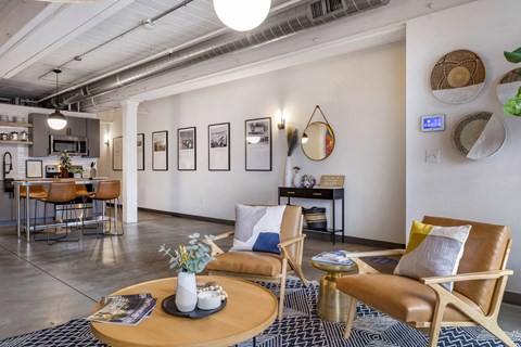 a living room with a couch and chairs and a table at Highland Mill Lofts, Charlotte, North Carolina