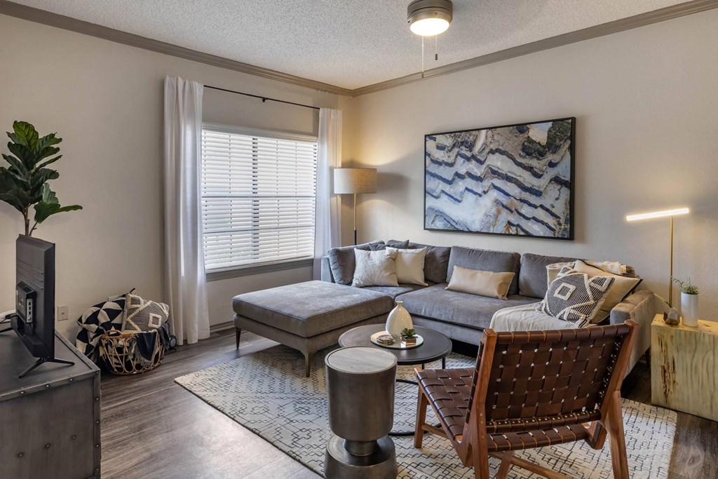 a living room with a couch and a tv at Lakeshore at Preston, Plano, Texas