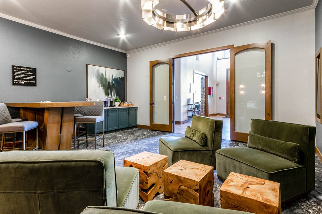 a living room with green couches and chairs and a table at The links at Plum Creek Apartments, Castlerock, 80104