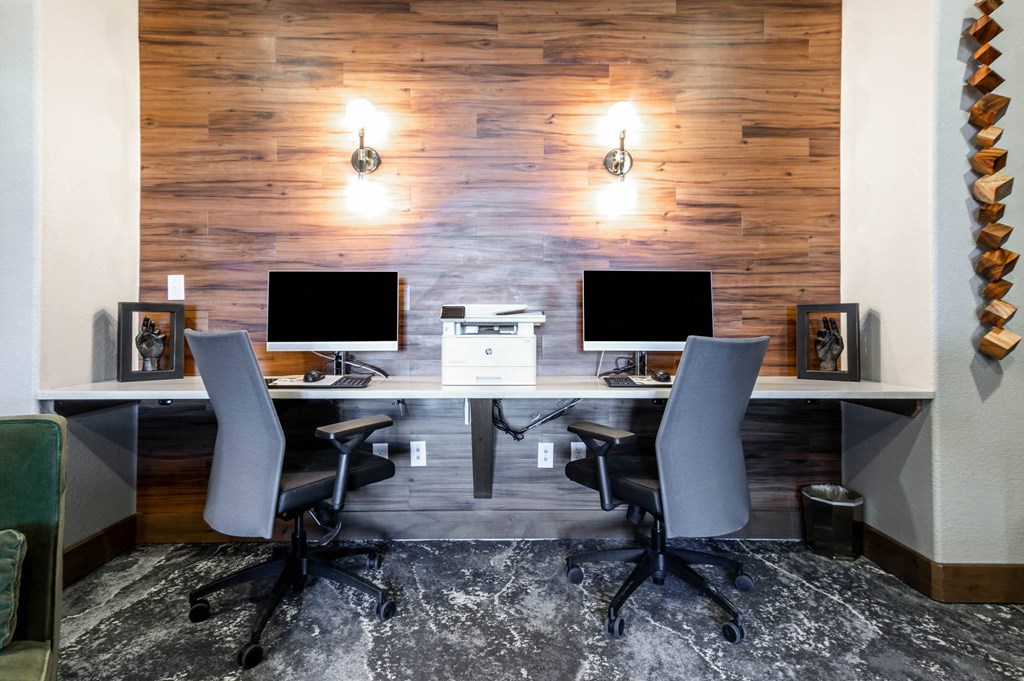 a conference room with two computer desks and chairs at The links at Plum Creek Apartments, Colorado, 80104