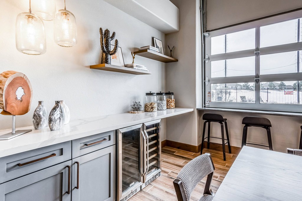 a kitchen with a large window and a table with chairs at The links at Plum Creek Apartments, Castlerock