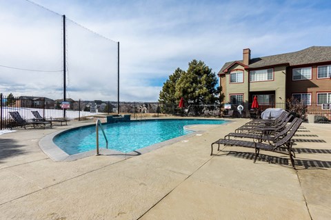 our apartments have a resort style pool with lounge chairs at The links at Plum Creek Apartments, Castlerock