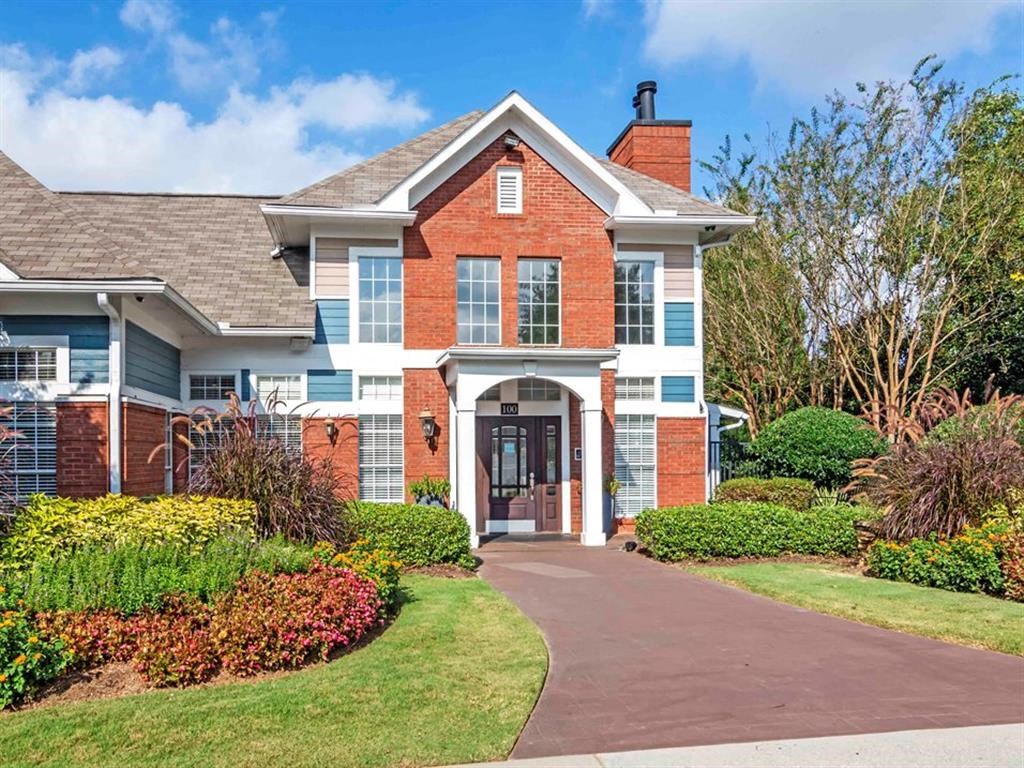 a large brick house with a walkway in front of it at Roswell Village, Georgia