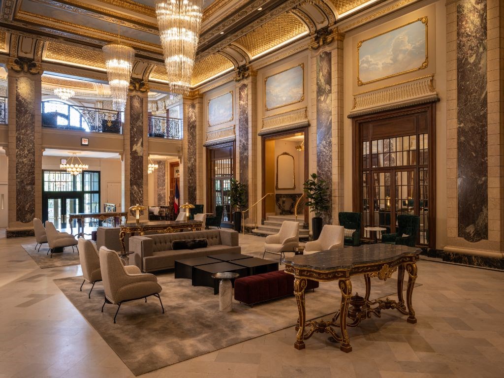 a large lobby with couches and chairs and a table  at The Belden Stratford, Illinois