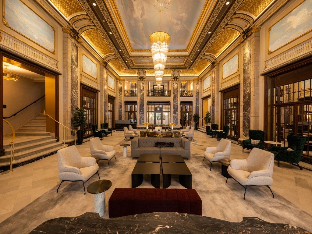 a rendering of the lobby with a reception area and chairs and tables  at The Belden Stratford, Chicago, 60614