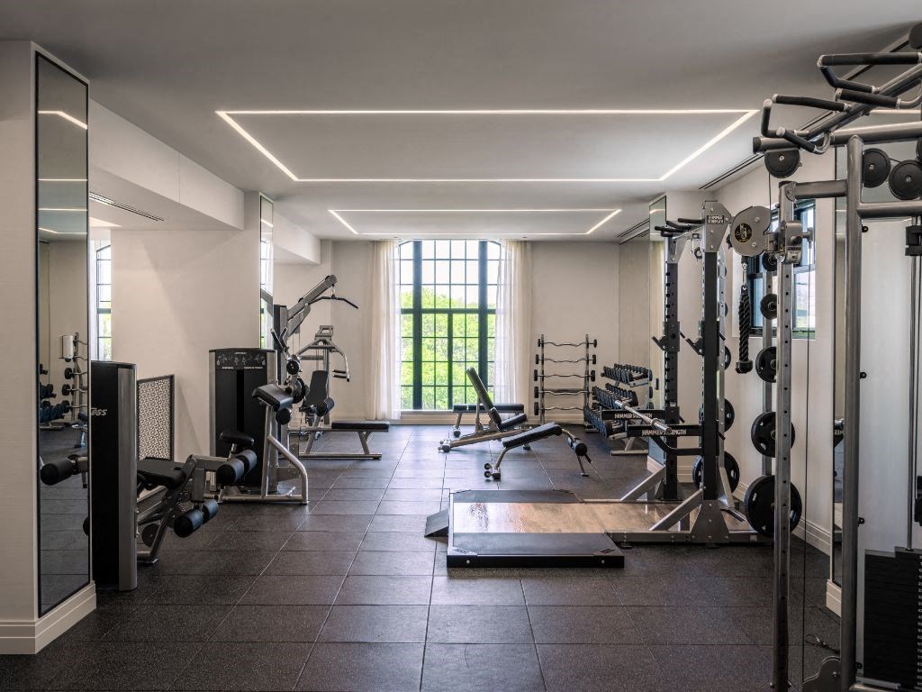 a gym with a lot of exercise equipment and a window  at The Belden Stratford, Chicago, IL, 60614