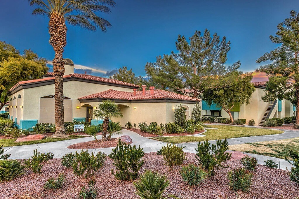 a house with a courtyard with plants and trees at Mirasol Apartments, Las Vegas, 89119
