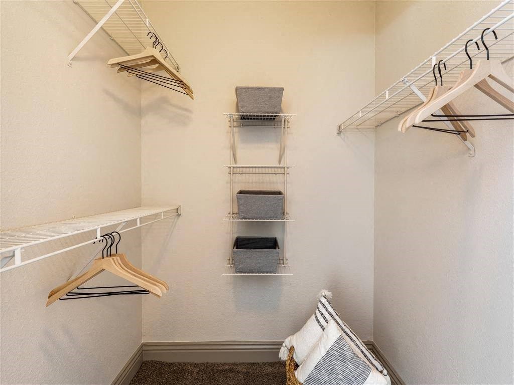 a walk in closet with racks and towels at Mirasol Apartments, Las Vegas