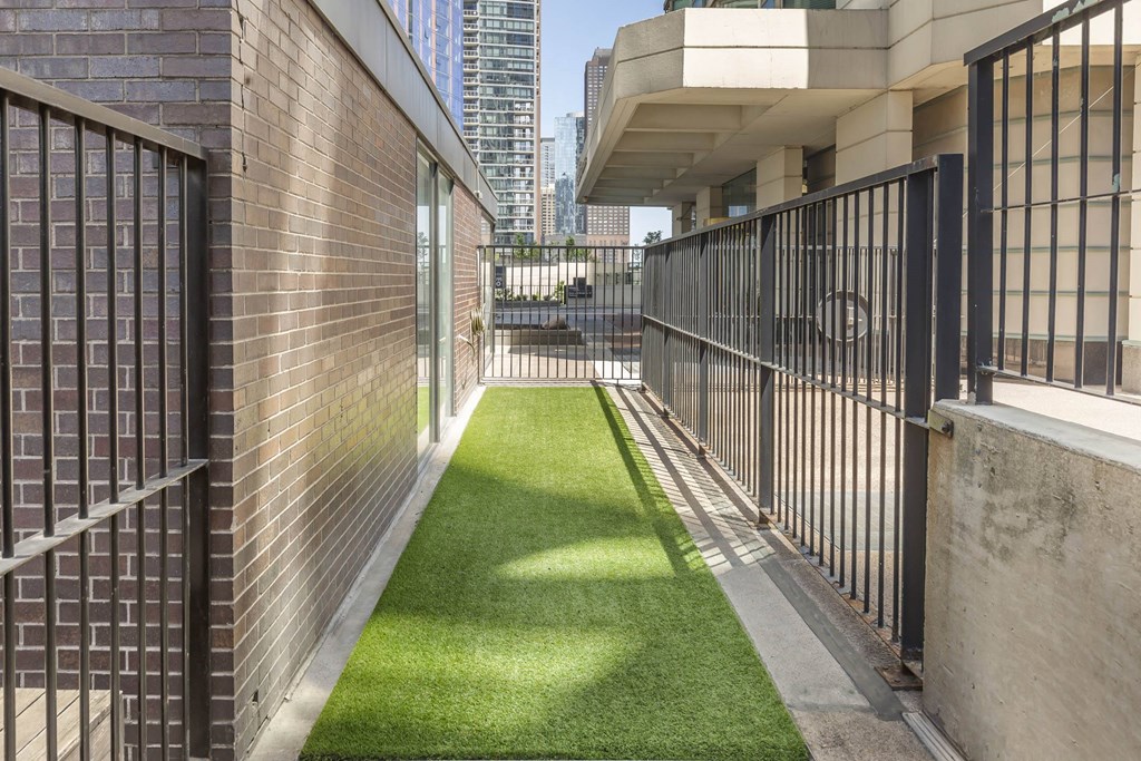 the yard of a building with fences and grass at North Harbor Tower, Chicago, IL