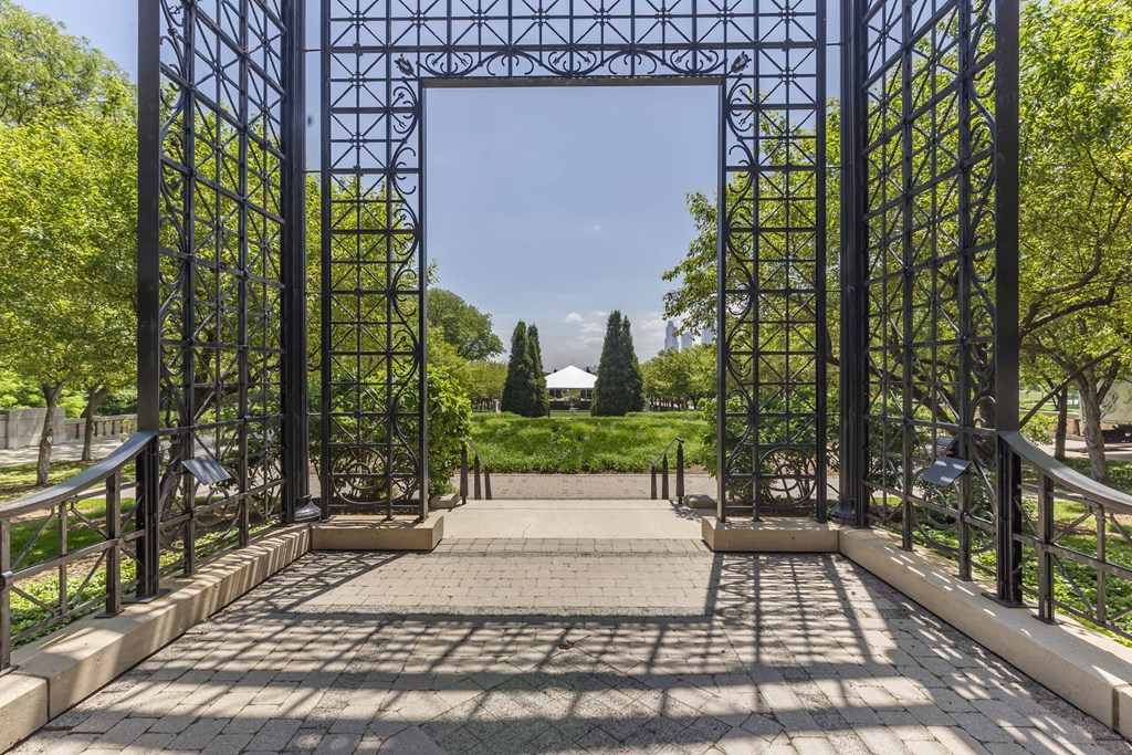 the entrance to a park with a metal structure and stairs at North Harbor Tower, Chicago