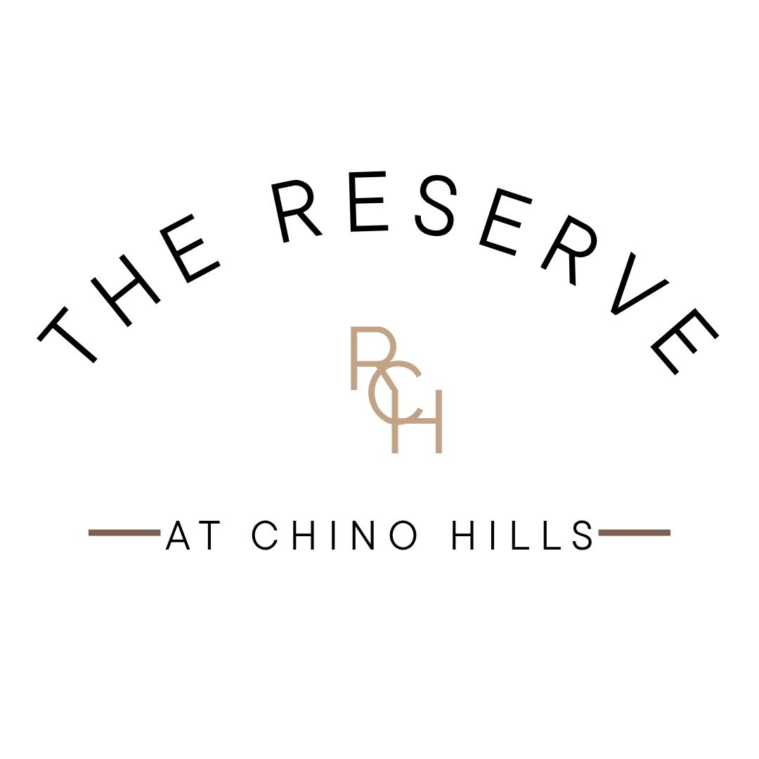 The Reserve at Chino Hills logo on a green background.