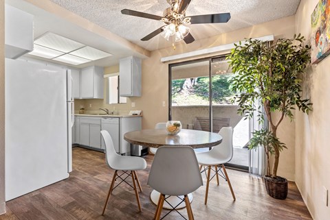 a dining room with a table and chairs and a kitchen