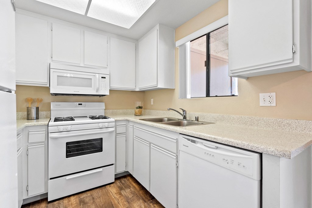 Kitchen with dishwasher at River Oaks in Oceanside, CA