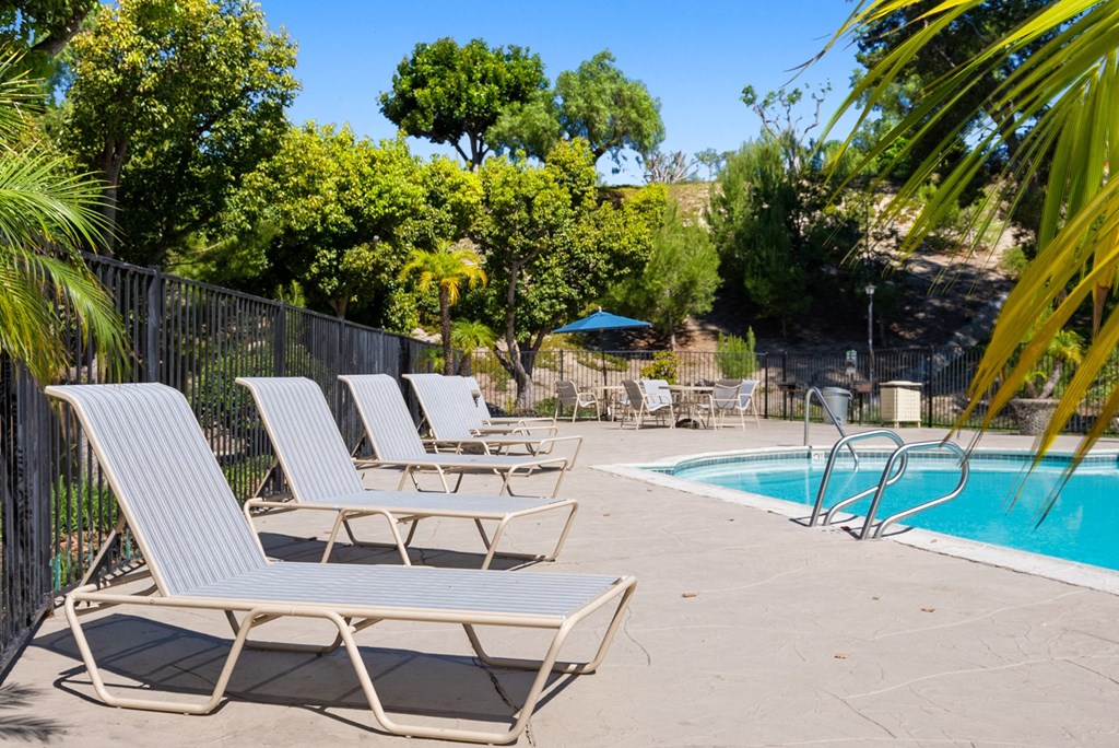 Pool-side lounge chairs at River Oaks in Oceanside, CA