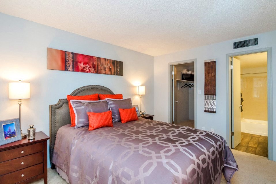 a bedroom with a bed and a door to a bathroom at Skyview Apartments, Colorado