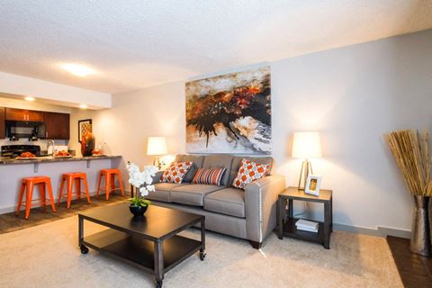 a living room with a couch and a table at Apartments at Denver Place, Colorado, 80202