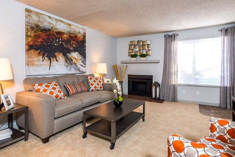 a living room with a couch and a coffee table at Apartments at Denver Place, Denver