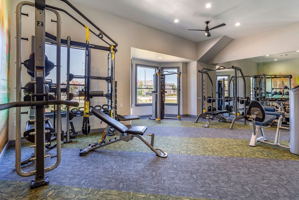a gym with weights and cardio equipment and a window at Sladestone Shadow Creek, Texas, 77584