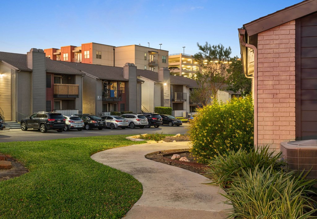 a view of a building with cars parked in a parking lot at South Lamar Village, Texas, 78704