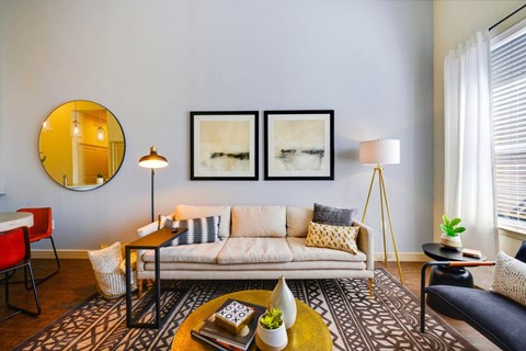a living room with a couch and three pictures on the wall at South Side Flats, Dallas