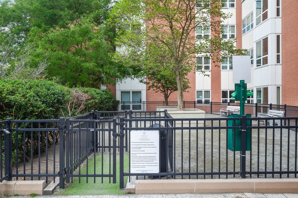 a sign on a fence in front of an apartment building at Amelia, Quincy, MA, 02169