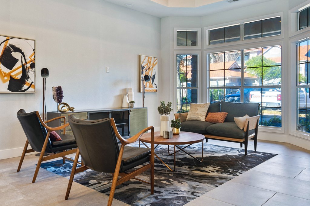 a living room with a couch and chairs and a fireplace
