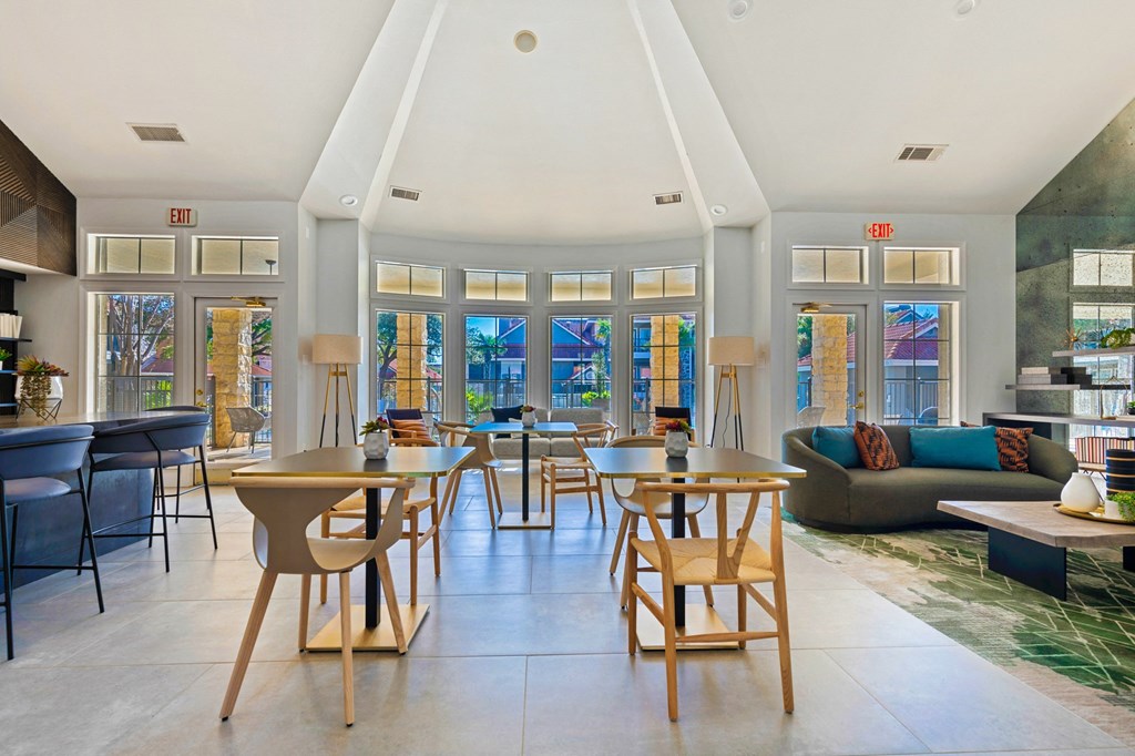 the living room and dining room of a house with tables and chairs