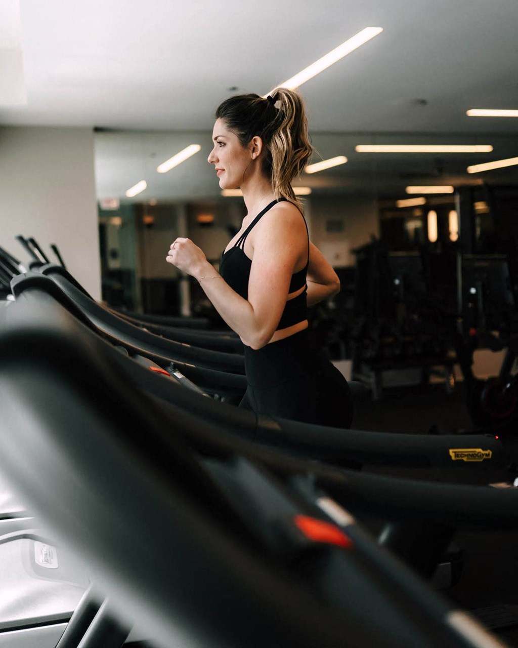 a woman running on a treadmill at the gym at The Grand Central, Illinois, 60607