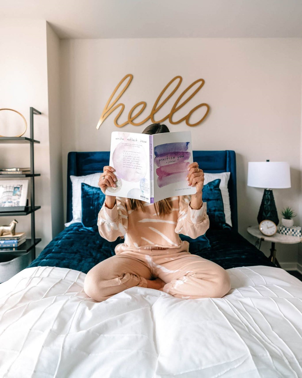 a girl sitting on a bed reading a book at The Grand Central, Chicago, IL 60607