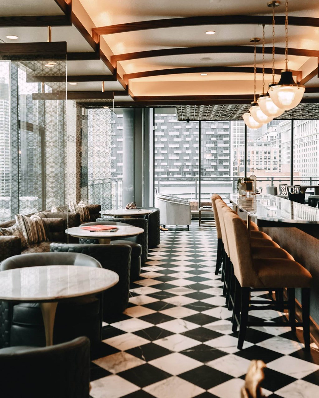 a black and white checkered floor with tables and chairs at The Grand Central, Chicago, IL
