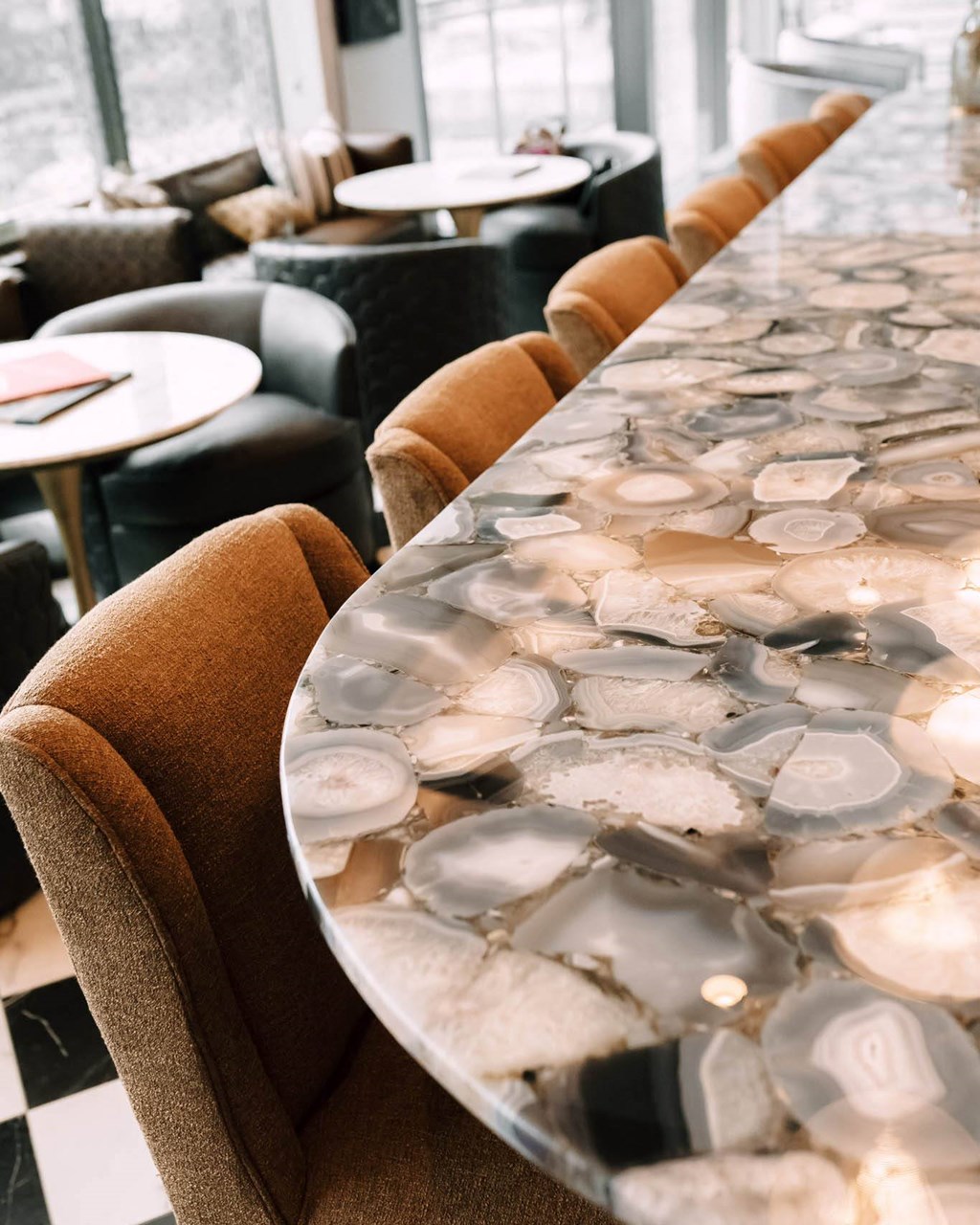 a long marble table with chairs at The Grand Central, Chicago, IL 60607
