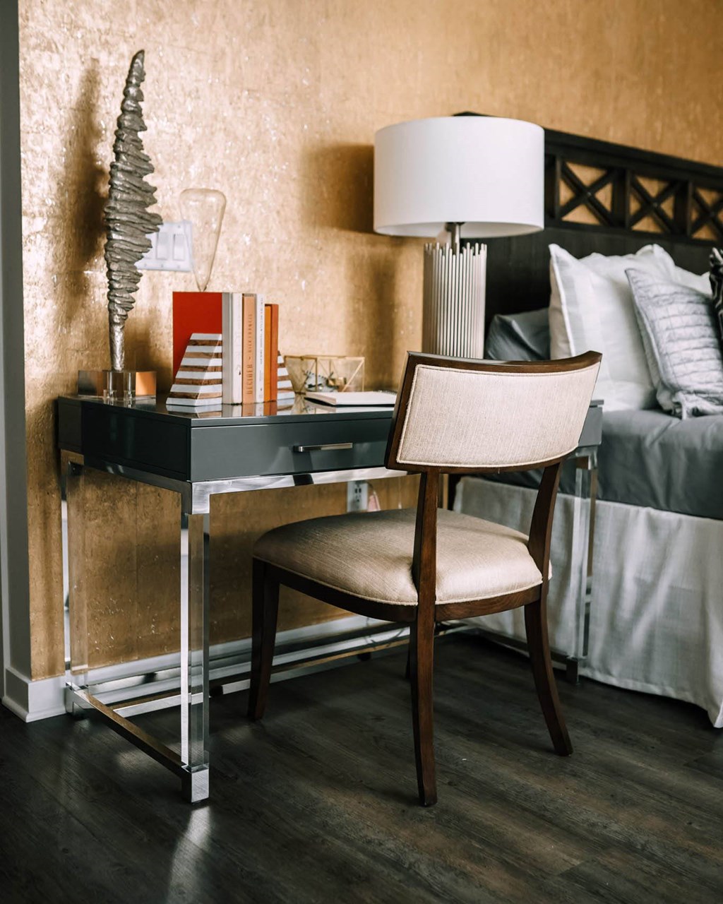 a desk with a lamp and a chair in a bedroom at The Grand Central, Illinois